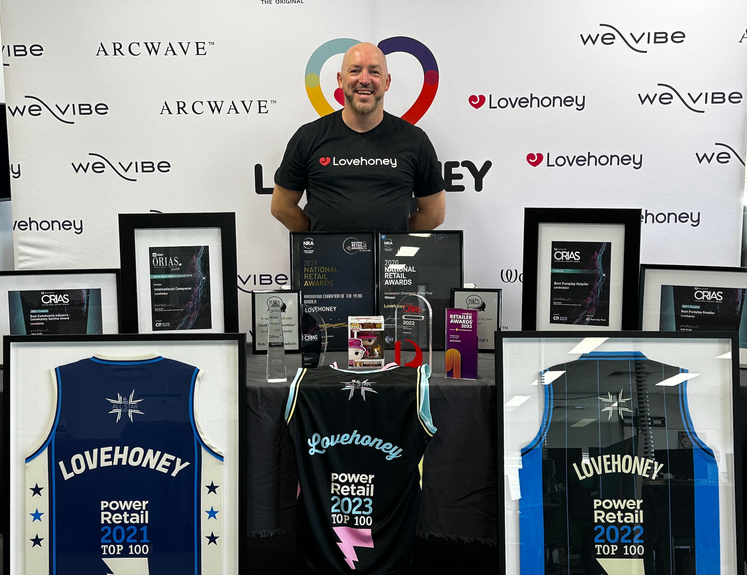 Rob Godwin in front of the Lovehoney awards wall